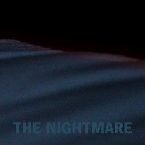 a bed in a dark room