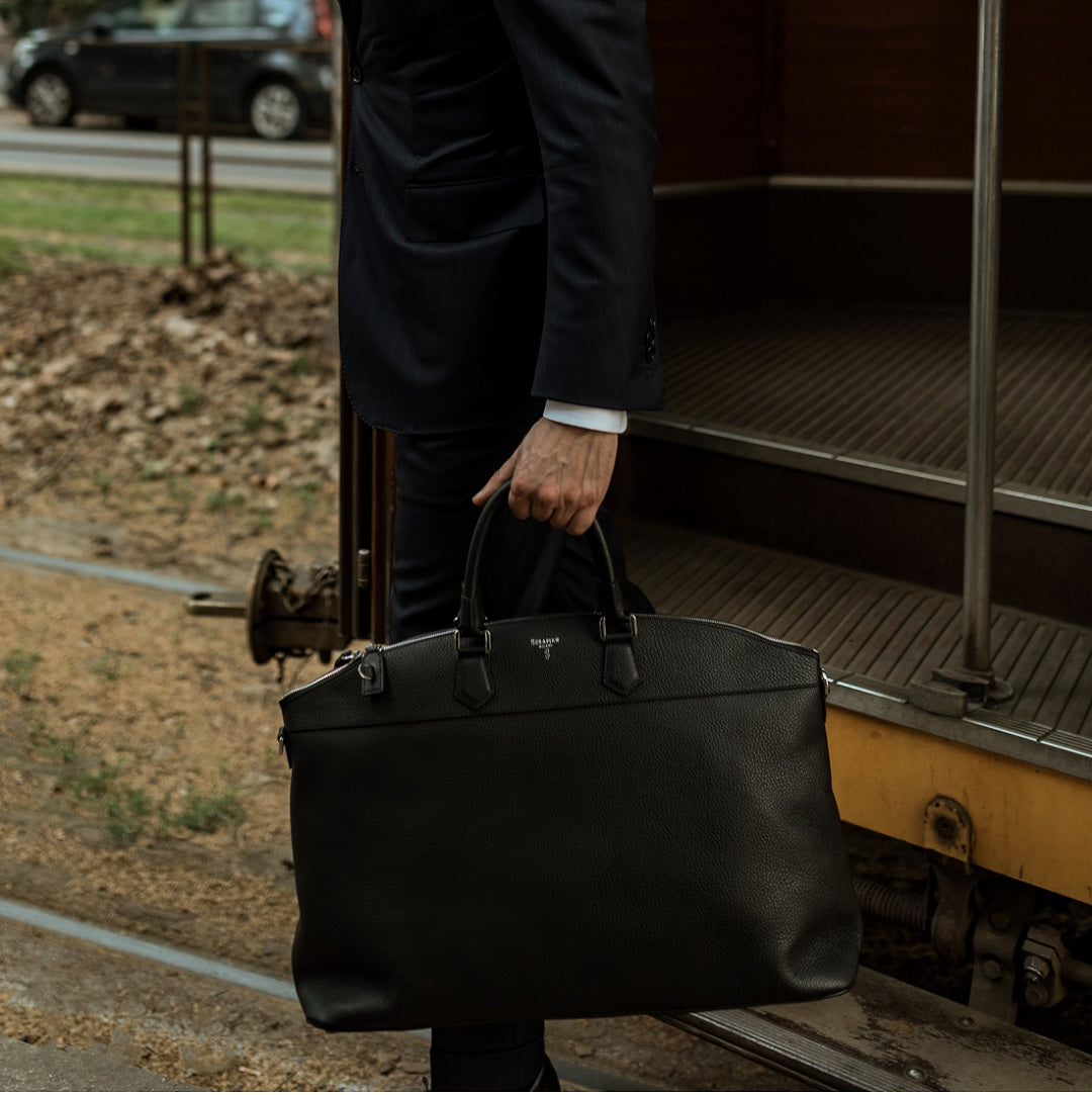 a person standing next to a suitcase