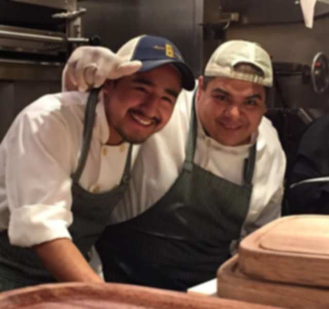 a person cutting a cake